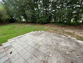 Apex house for rent - a wooden deck with trees in the background