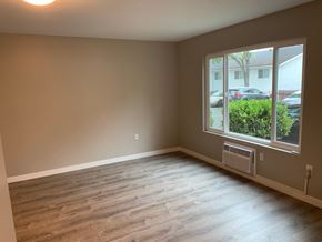 Fallbrook apartment for rent - an empty living room with wood floors and a large window