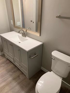 Fallbrook apartment for rent - a bathroom with a toilet and a sink and a mirror