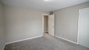 Raleigh apartment for rent - an empty living room with a door to a hallway