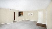 Raleigh apartment for rent - an empty living room with white walls and a window