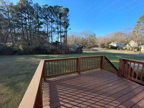 Raleigh house for rent - a large deck with a view of a field and trees