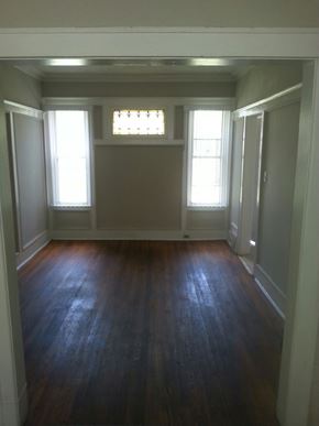 Detroit apartment for rent - A room with wooden floors and white walls.