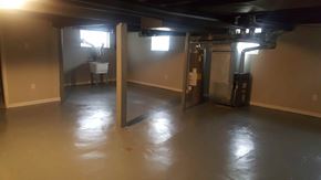 Detroit apartment for rent - A large empty room with a table and chairs in the background.