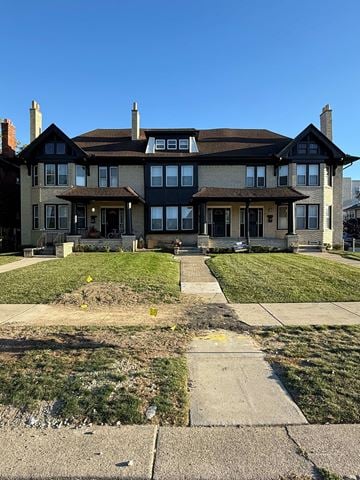 Detroit apartment for rent - A large house with a dark roof and a stone foundation.