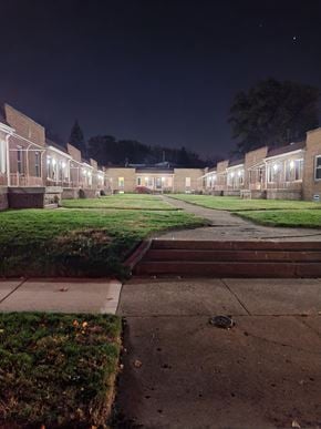 Pontiac apartment for rent - A long building with a lot of windows is lit up at night.