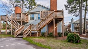 Raleigh apartment for rent - the front of a house with a deck and stairs