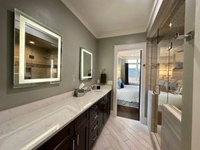 Greenville house for rent - a bathroom with a long counter and a shower and a bed