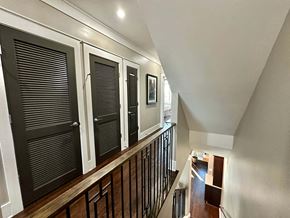 Greenville house for rent - the entryway of a house with black doors and a staircase