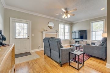 Bristol house for rent - a living room with couches and chairs and a ceiling fan