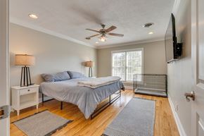 Bristol house for rent - a bedroom with a bed and a ceiling fan