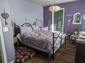 Pagosa Springs house for rent - a bedroom with purple walls and a bed with a comforter
