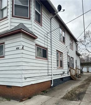 Cleveland apartment for rent - the side of a white house with a red brick