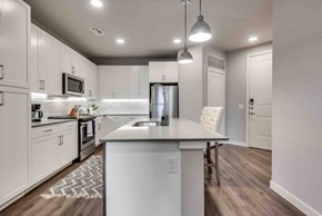 Mckinney house for rent - a white kitchen with an island in the middle