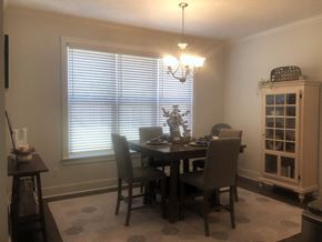 Aiken house for rent - a dining room with a table and chairs and a window