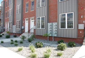 Philadelphia apartment for rent - the front of a brick building with plants in front of it