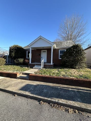 Hopkinsville house for rent - a small brick house with a white front door