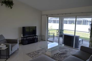 Cape Coral house for rent - a living room with a couch and a television