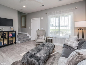 Waukee apartment for rent - A living room with a grey couch and a grey rug.