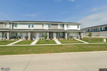 Waukee apartment for rent - a row of houses with grass and sidewalks