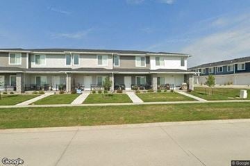 Waukee apartment for rent - a row of houses with grass and sidewalks
