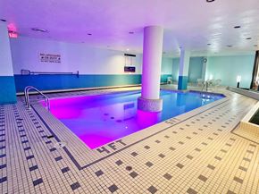Edmonton apartment for rent - a swimming pool with a blue and purple light on the floor
