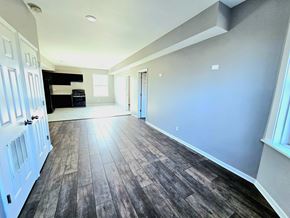 Chicago apartment for rent - A room with wooden flooring and white walls.