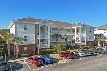 Little River house for rent - a large building with cars parked in front of it