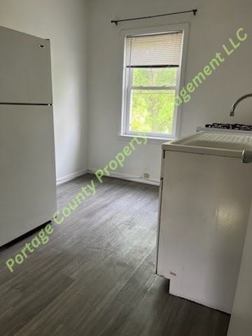 Stevens Point apartment for rent - A kitchen with a white fridge and a white stove top oven.