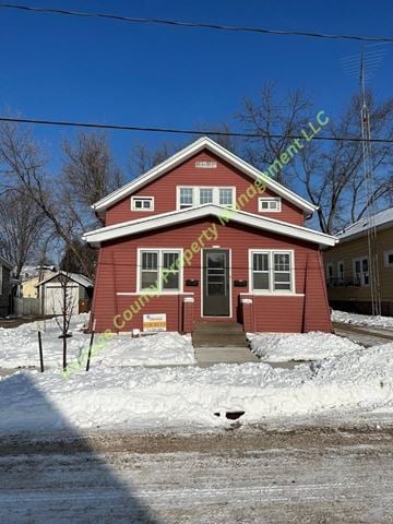 Stevens Point apartment for rent - A red house with a yellow sign on the front door.