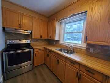Belleville apartment for rent - a kitchen with wooden cabinets and stainless steel appliances