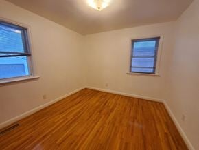 Belleville apartment for rent - a bedroom with a hard wood floor and two windows