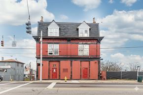 Cincinnati apartment for rent - A red building with a white window and a red door.