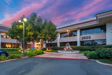 Westlake Village apartment for rent - The image shows a building with the number 2659 on it, surrounded by greenery and a clear sky.
