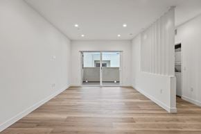 Los Angeles apartment for rent - A spacious room with wooden floors and white walls.