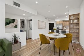 Los Angeles apartment for rent - A dining room with a white table and yellow chairs.