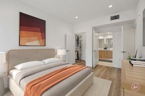 Los Angeles apartment for rent - A bedroom with a large bed and a painting on the wall.