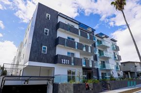 Los Angeles apartment for rent - a city building with a palm tree in front of it