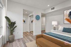Los Angeles apartment for rent - a bedroom with white walls and a bed and a couch