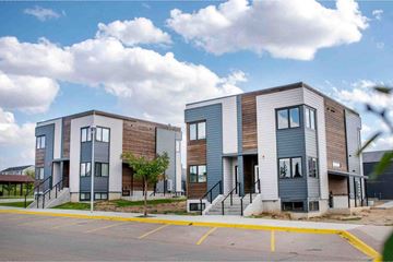 Winnebago apartment for rent - a group of three multifamily buildings with stairs in front of a street