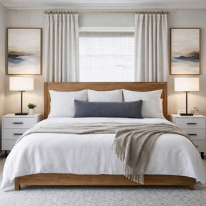 Tampa apartment for rent - A bedroom with a large bed, two lamps, and two framed pictures on the wall.