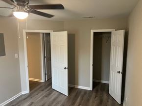 Decatur apartment for rent - A room with a ceiling fan and three doors.