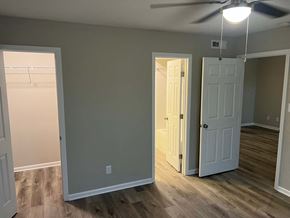 Decatur apartment for rent - A room with a ceiling fan and two doors.