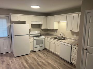 Decatur apartment for rent - A kitchen with white appliances and cabinets.