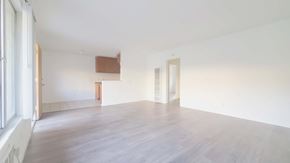 Anaheim apartment for rent - A room with white walls and wooden flooring with a window on the left.