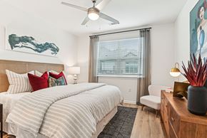 Charlotte apartment for rent - A bedroom with a large bed and a painting on the wall.