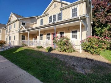 Bloomsburg apartment for rent - a large yellow house with a sidewalk in front of it