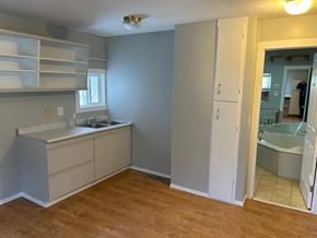 Prince Albert house for rent - A bathroom with a sink, a mirror, and a bathtub.