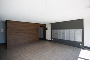 Los Angeles apartment for rent - a large room with a wall of mailboxes and a door