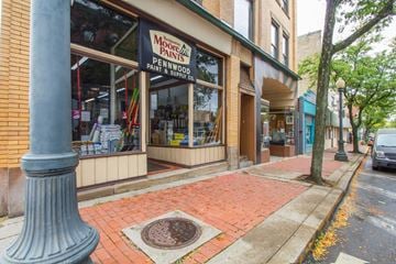 Pittsburgh apartment for rent - a sidewalk in front of a store on a city street